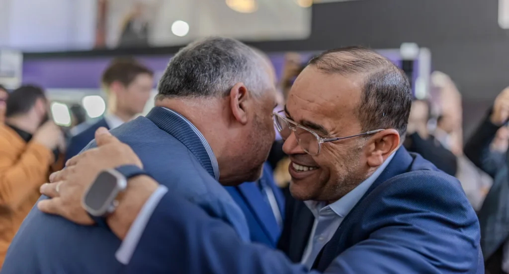 Two exhibitors greeting each other
